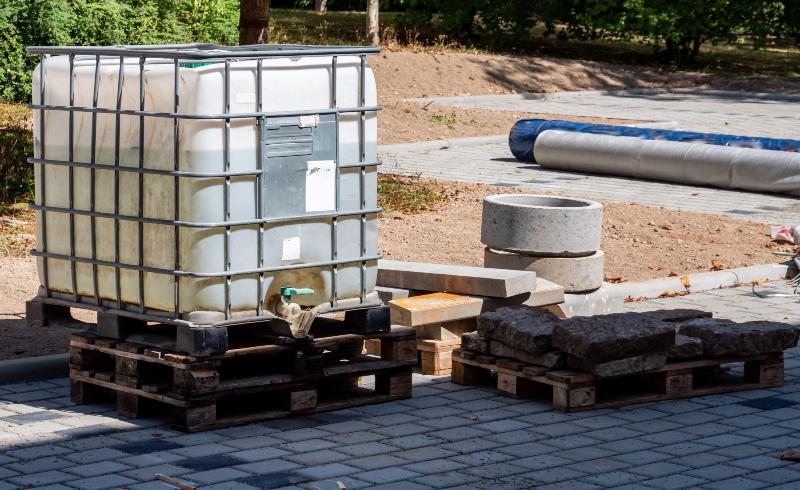 Ein IBC-Container steht im Umfeld einer Baustelle. Kombinations-IBC